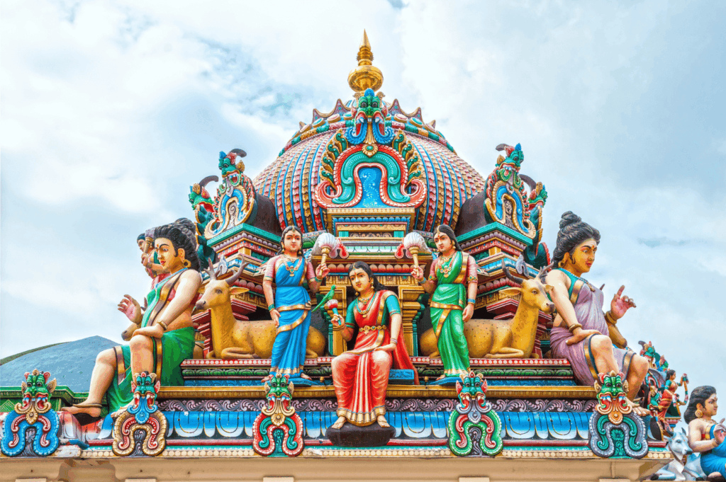 Vibrant gopuram detail of a Hindu temple in Singapore, showcasing colorful deities and ornate carvings—an architectural gem tucked off the tourist trail, perfect for cultural photography.