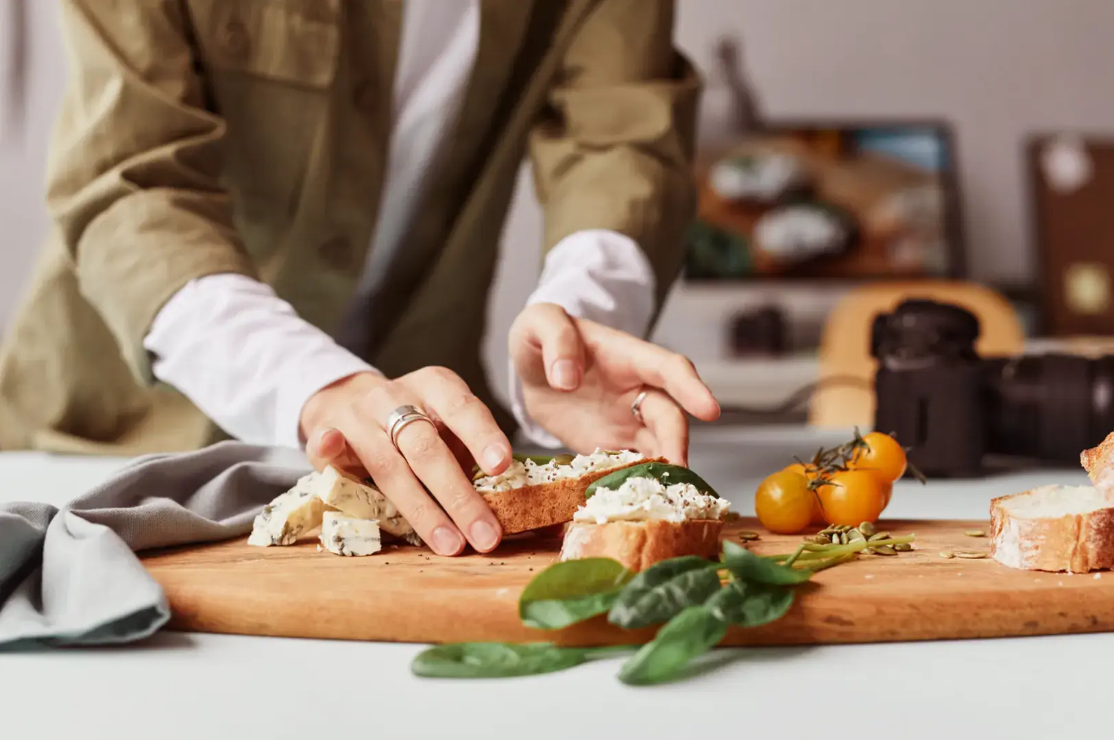 Food stylist arranging dishes on a board