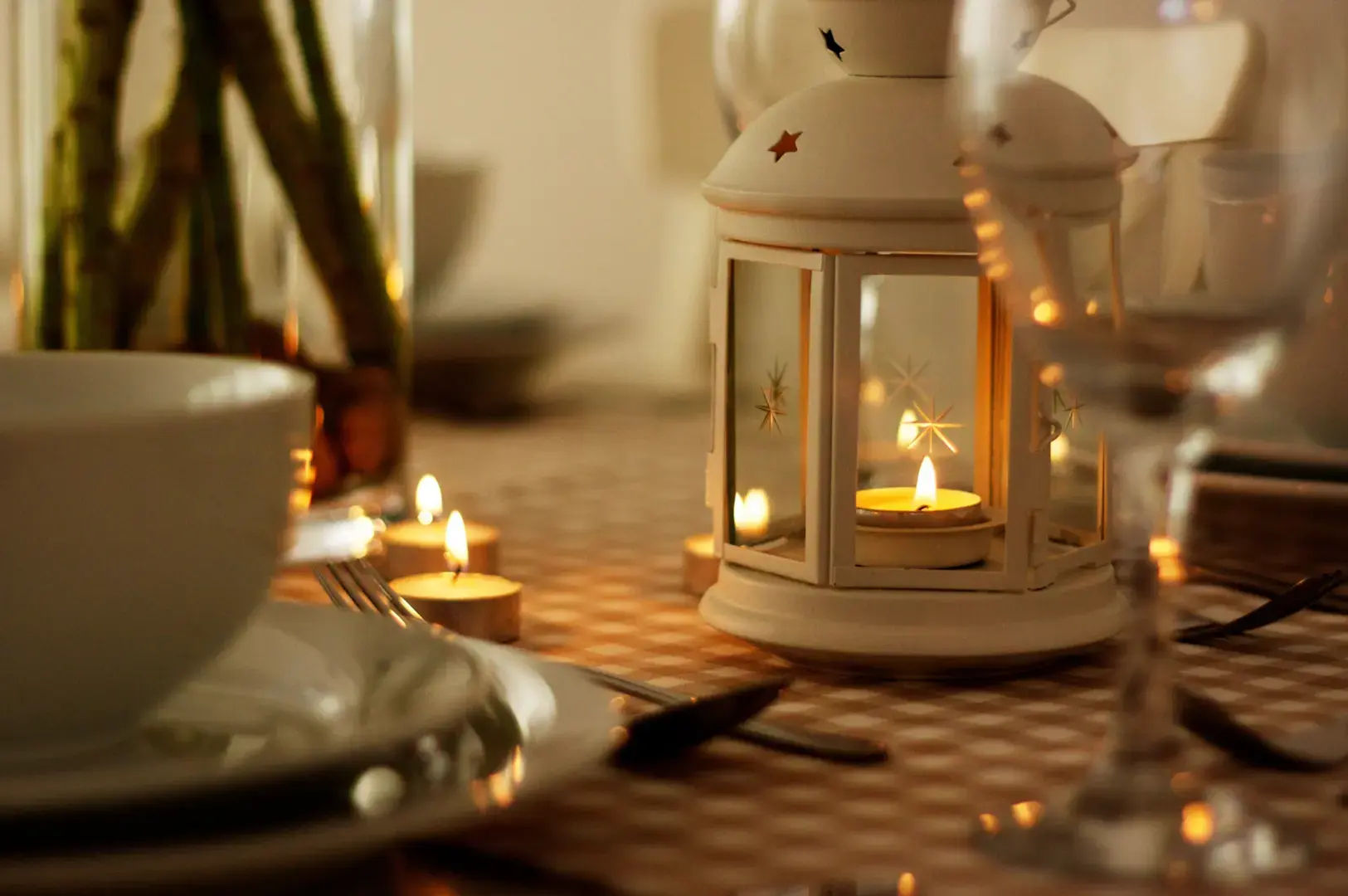Candlelit dining table with lantern centerpiece
